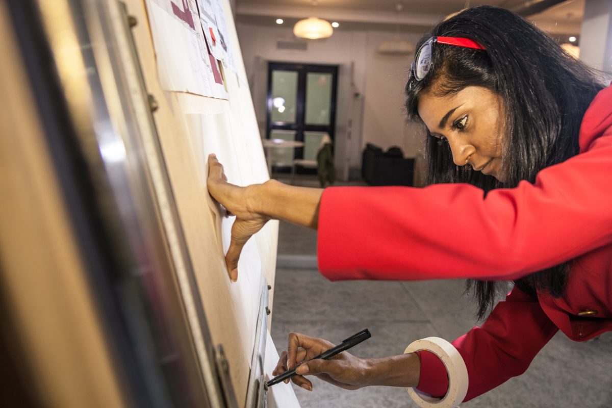 Image of a young indian asian woman working on her research presentation