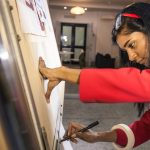 Image of a young indian asian woman working on her research presentation