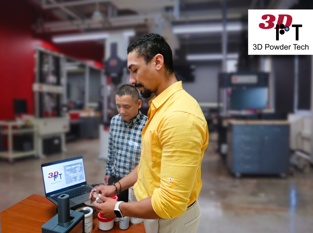 two men stand and talk in a lab with scientific equipment.