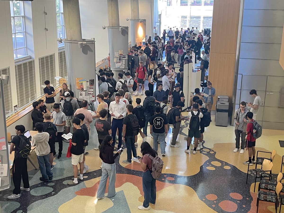 dozens of people mingle in the large room