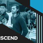 Transcend logo with a photo of two men talking to another person