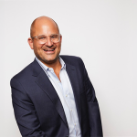 white man with a buzz cut and glasses