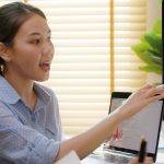 woman pointing to a screen with an xray